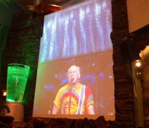 Jimmy Buffett appears at his club. On the big screen, that is.