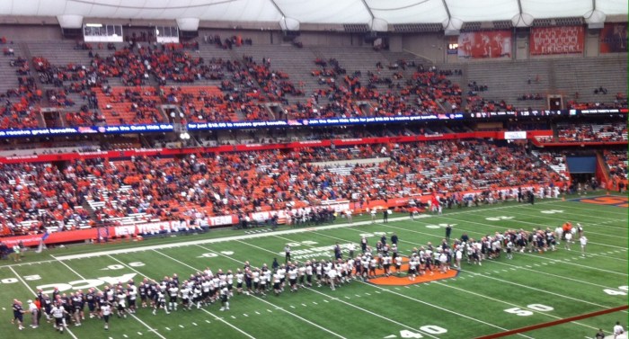 Before the game started, college football players from Syracuse and Wake Forest met at midfield to shake hands.