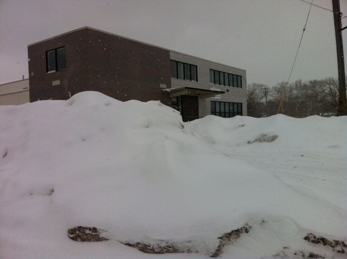 There is a building behind that snow mound in Syracuse, N.Y.