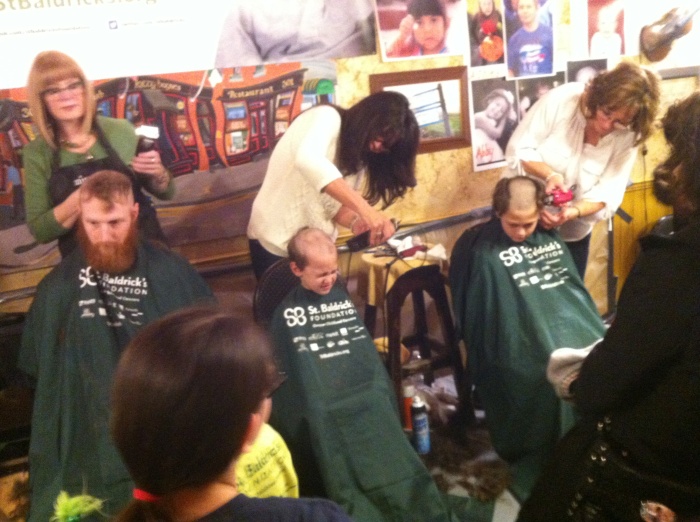 Two children and a hairy man get their heads shaved today at the downtown Syracuse edition of St. Baldrick's, the national organization that contributes in the fight against childhood cancers.