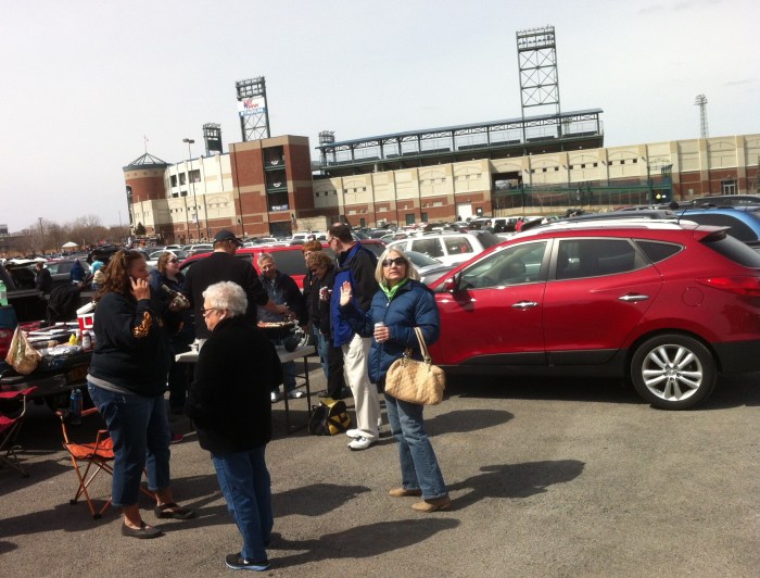 My dear wife Karen, center, with 20 of our friends celebrating the baseball season that looms in NBT Bank Stadium behind her.