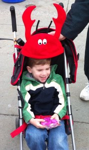 Evan Eggert of Syracuse doesn't really want to wear his Crawfish hat, but mom Julie cooperates for the photo opp.