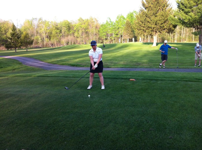 Morelli tees off on No. 16. with Bird and DJ looking on.