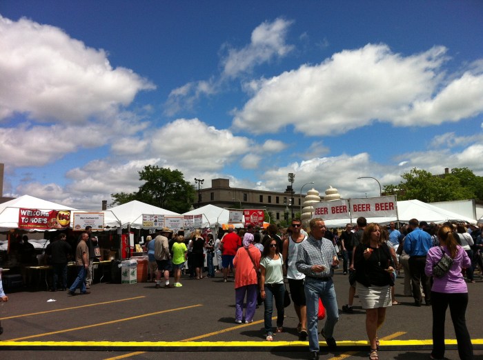 People and booths around Clinton Square.