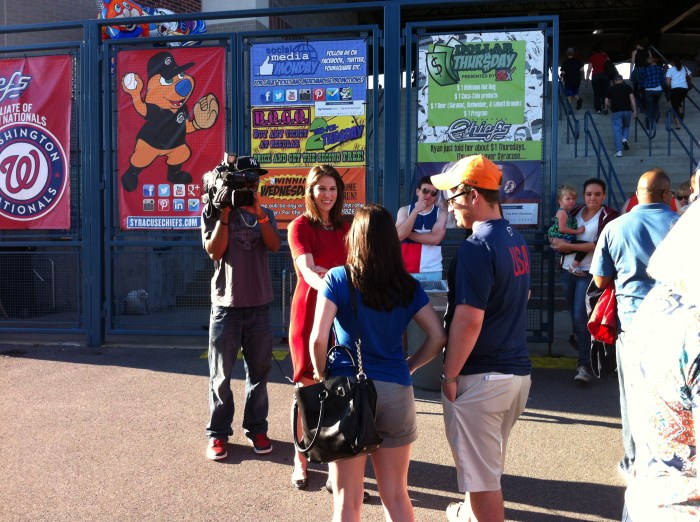 TV crews interview baseball fans before they enter NBT Bank Stadium Friday in Syracuse.
