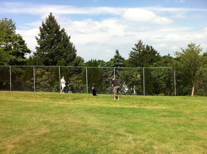 George chips to the green.