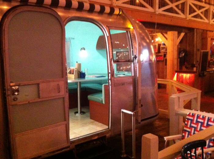 On one side, a trailer, parked.