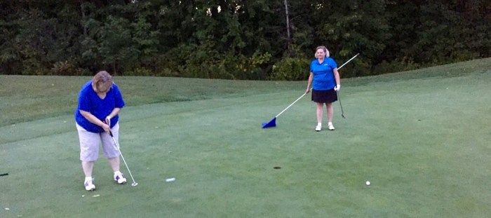 Commish tends the flag for ... yes, her mom's putting stroke. 