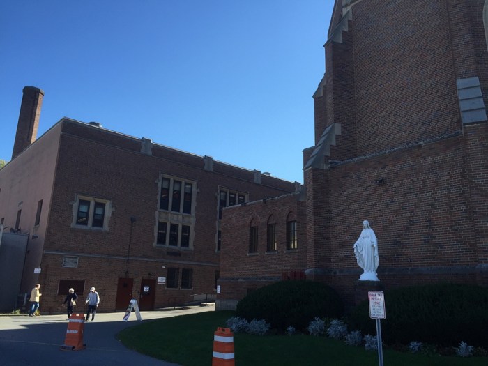 Left of the Virgin Mary.