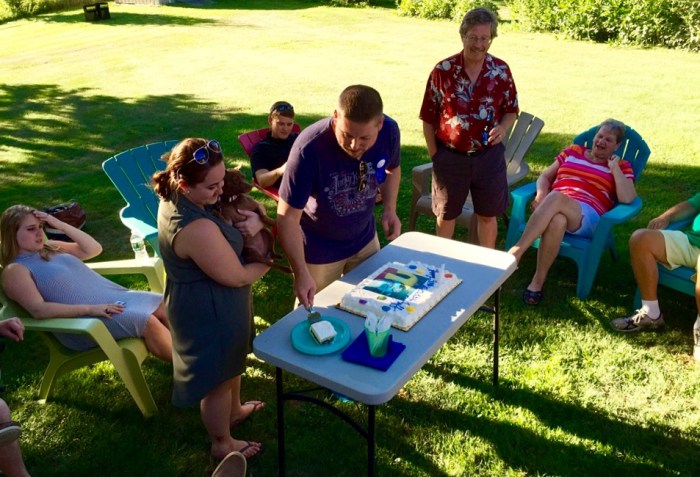 Birthday boy cuts his cake.