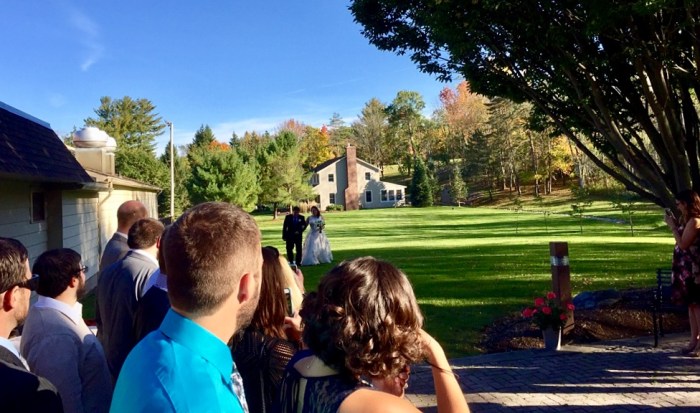 Kristin is walked in by her dad.